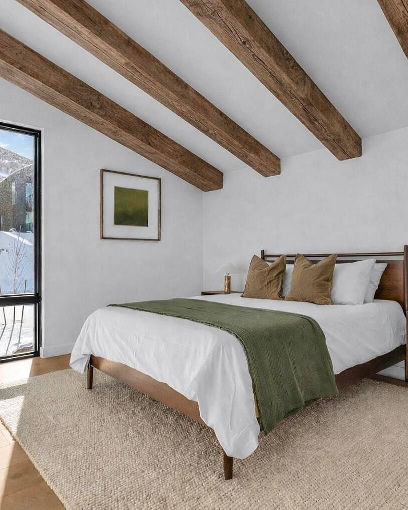 Primary suite with exposed timber beams and mountain views at The Skyfall Residence, Park City luxury home rental